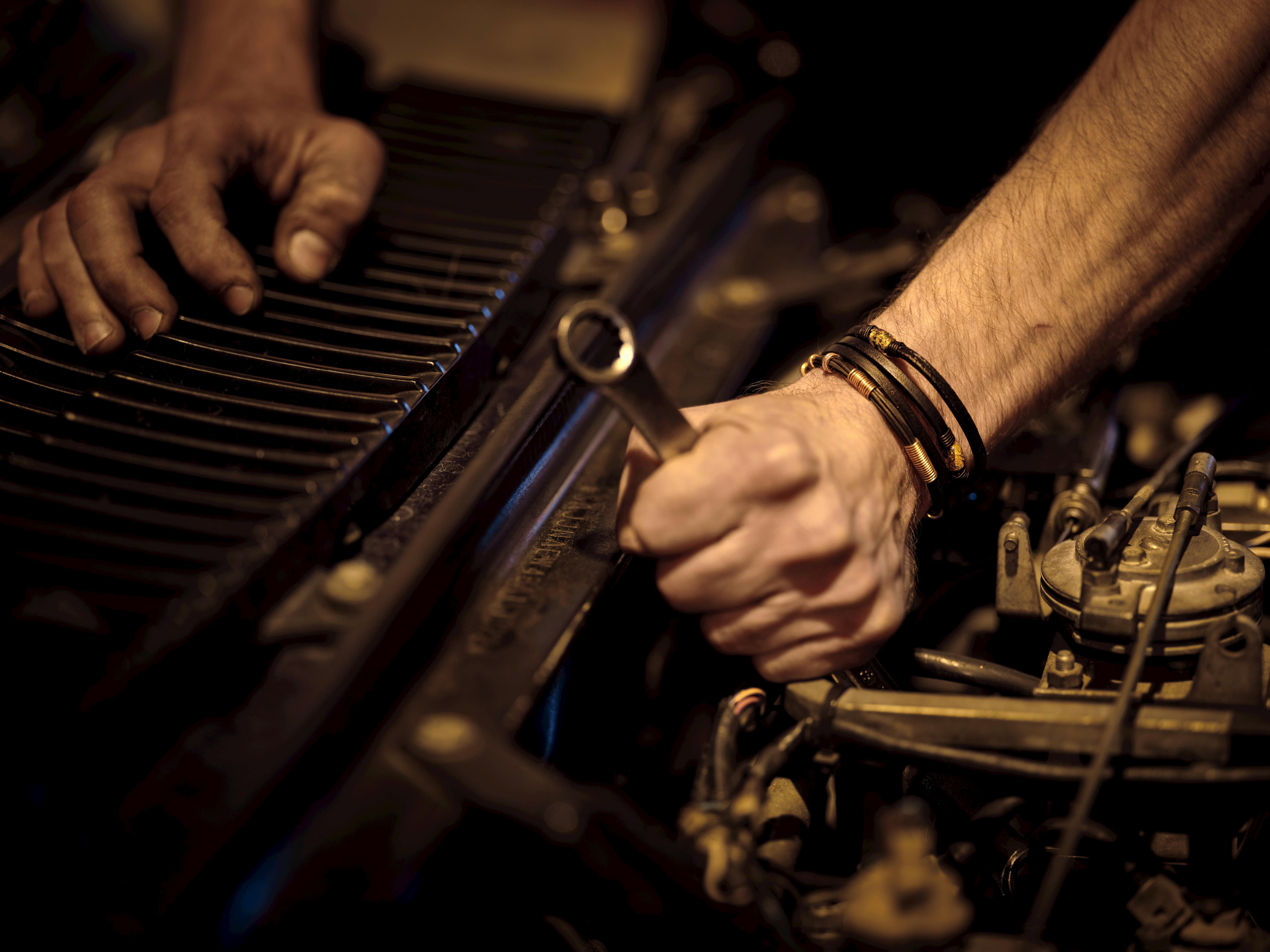 Close-up hands carrying out a low-light wiring repair.